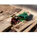 A sunlit sachet of Nana's Apple Pie potpourri by Irish Twins Potpourri sits on an old pallet with a wooden fence blurred in the background.